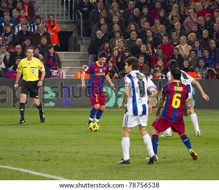 BARCELONA - DECEMBER 13: David Villa (L) in action during the Spanish Soccer League match between FC Barcelona and Real Sociedad, 5 - 0, in Camp Nou stadium on December 13, 2010 in Barcelona, Spain.