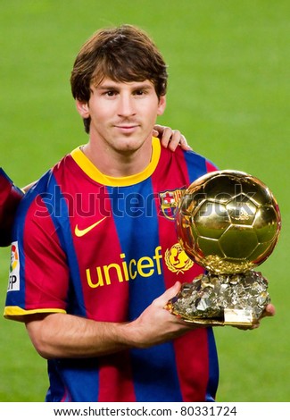 BARCELONA - JANUARY 12: Leo Messi offers the FIFA World Player Gold Ball Award to the supporters of Football Club Barcelona. January 12, 2011 in Nou Camp stadium, Barcelona, Spain.