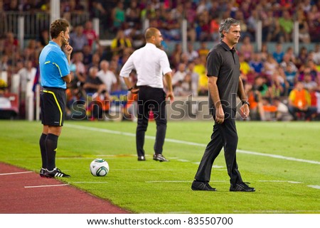 BARCELONA - AUGUST 17: Jose Mourinho (R) and Pep Guardiola (M) during the Spanish Super Cup final match between FC Barcelona and Real Madrid, 3 - 2, on August 17, 2011 in Camp Nou, Barcelona, Spain.