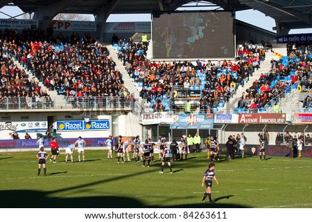 PERPIGNAN - JANUARY 2: Supporters and players during the Rugby Top14 French Championship match between USAP Perpignan (blue) and Brive, final score 23 - 16, on January 2, 2011 in Perpignan, France.