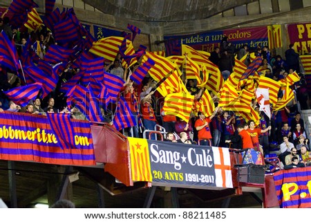 BARCELONA - MARCH 24: Unidentified Barcelona supporters cheer during the Euroleague basketball match Barcelona - Panathinaikos, 71-75, on March 24, 2011 in Palau Blaugrana stadium in Barcelona, Spain.