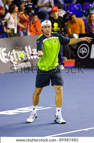 BARCELONA - OCTOBER 22: David Ferrer in action during a tennis match organized as a tribute to Andreu Gimeno, on October 22, 2011, in Palau Blaugrana stadium, Barcelona, Spain.