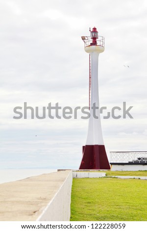 The main lighthouse guiding in ships to the very shallow port of Belize City, Belize on an overcast day.