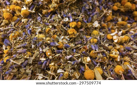 A background of loose herbal tea with lavender, chamomile and lemon verbena.