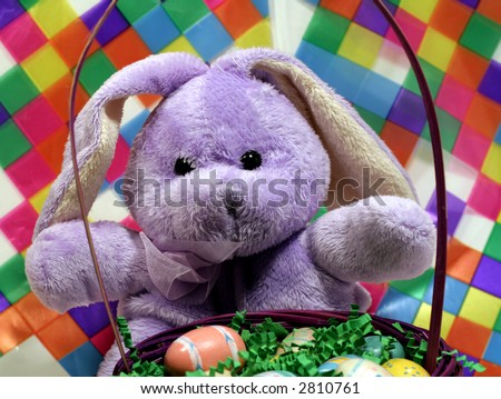 Purple stuffed Easter bunny with basket and colorful background