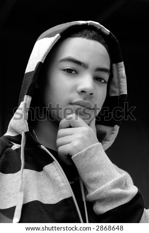 Portrait of multi-cultural teen boy with hooded sweatshirt in black and white