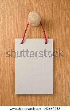 Paper signboard with rope hanging on a handle of door