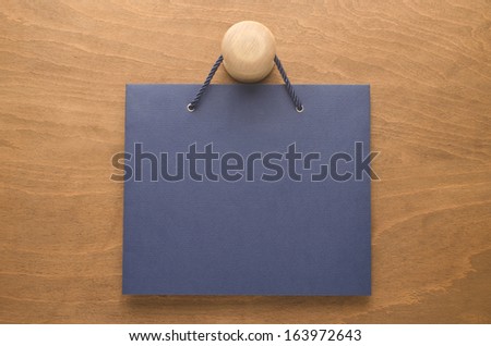 Blue paper with rope hanging on a handle of door