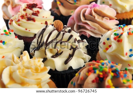 A variety of delicious cupcakes on a white background