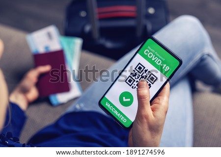 vaccinated person using digital health passport app in mobile phone for travel during covid-19 pandemic. green certificate