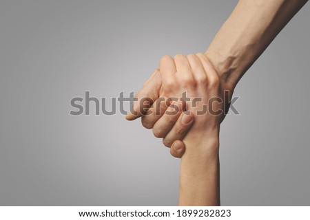 help friend through a tough time. rescue gesture. support, friendship and salvation concept. holding hands