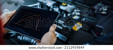car engine ecu remapping and diagnostics. mechanic using digital tablet to check vehicle performance after chiptuning Photo stock © 