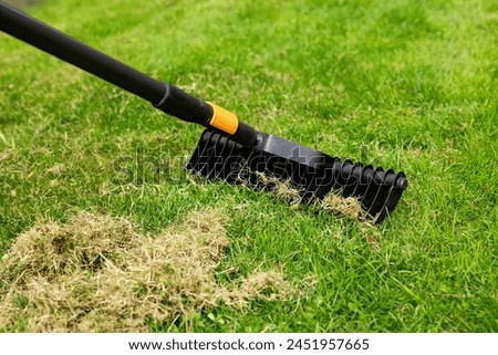 Similar – Image, Stock Photo Spring gardening. Scarifying in the garden to improve the quality of the lawn in the spring.