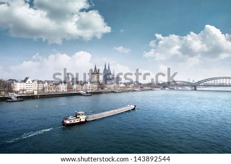 Cologne city line with cargo ship on rhine