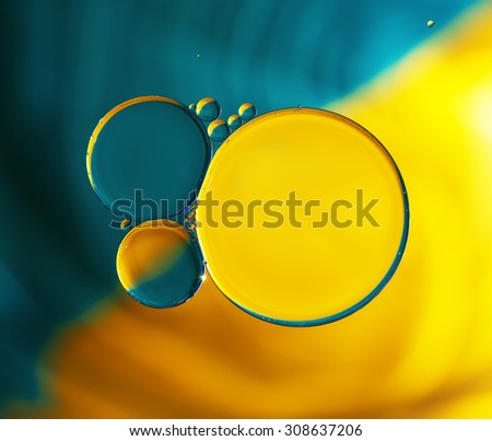 Abstract background, colorful oil droplets on water surface. Beautiful macro abstraction