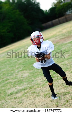 Youth football player catching a football