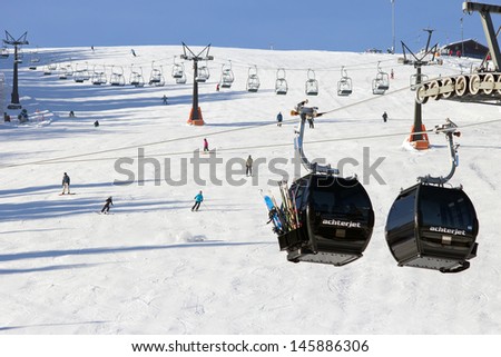 FLACHAU, AUSTRIA - DEC 29: Ski lift cable booths going up the piste in Flachau, Austria on Dec 29, 2012. These pistes are part of the Ski Armada network, the largest of Europe.