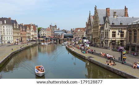 GHENT - JUN 18: Tourists and students in the historical center of Gent with it's gabled houses along the canal in Gent June 18, 2013 in Ghent, Belgium