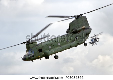 GILZE-RIJEN, NETHERLANDS - JUNE 21: Dutch Air Force CH-47 Chinook and AH-64 Apache performing a display at the Royal Netherlands Air Force Days June 21, 2014 in Gilze-Rijen, Netherlands.