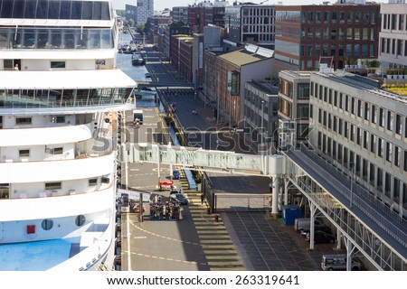 AMSTERDAM - SEP 2, 2014: A cruise ship is docked at Passenger Terminal Amsterdam (PTA). The terminal is in use since 2000 and is 600 meters long to accommodate large cruise ships.
