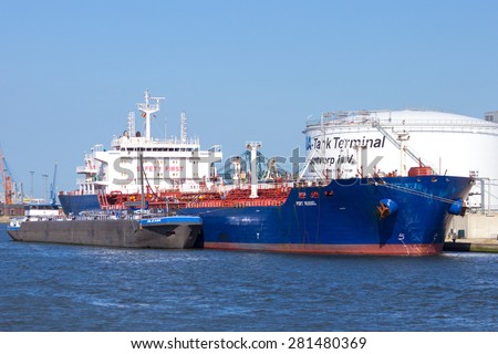 ANTWERP, BELGIUM - JULY 9: Oil tanker Port Russel moored near an oil silo in Port of Antwerp July 9,2013 in Antwerp, Belgium. The Port is the Europe\'s second largest sea port after Rotterdam.