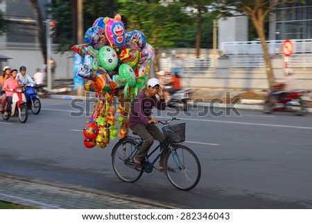 Ho CHI MINH, VIETNAM - AUG 23, 2009: An unidentified street vendor on a bicycle in Ho Chi Minh City (Saigon). There are many street vendors in Saigon.