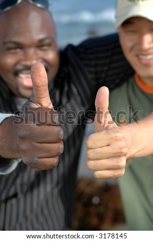 Two young friends giving a thumbs up sign.  Life\'s good...life\'s very good :)
