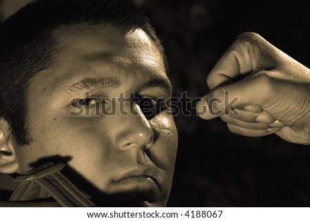 Film noir stylized tough guy portrait in a sepia tone.