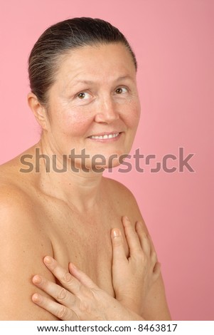 Soft and intimate portrait of a naturally beautiful older woman; no makeup, just great skin