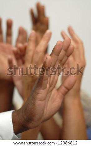 Many hands going up either in a question or during an election