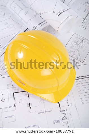 Building plans and yellow hardhat