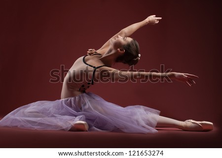 young beautiful ballerina sitting on the floor
