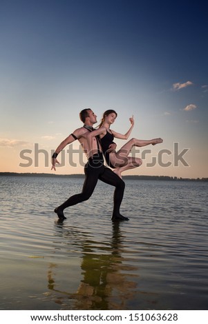 Two young men dancing on the surface of the water
