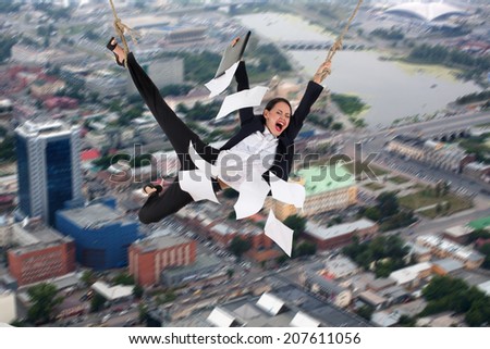 Risking business lady with flying papers near her is soaring above the city