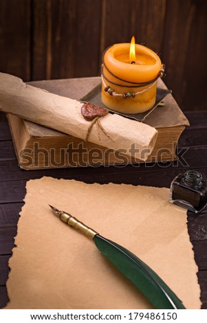 Old paper, candle and quill pen vertical