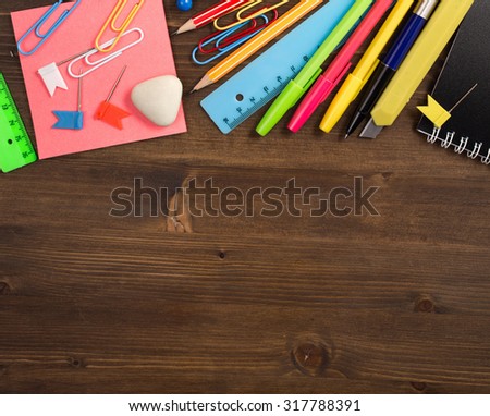 Stationery items at top of wooden table top view