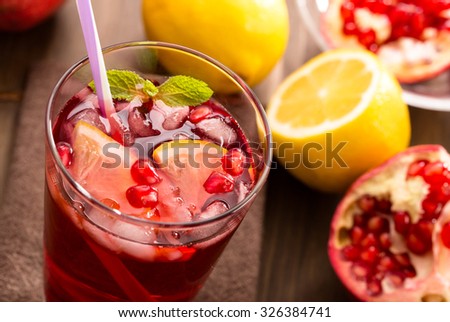 Pomegranate with lemon and ice. Refreshing drink.Top view.