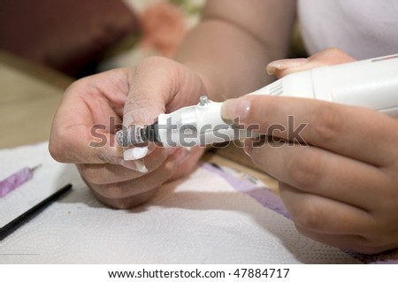 Woman's hands with nail file
