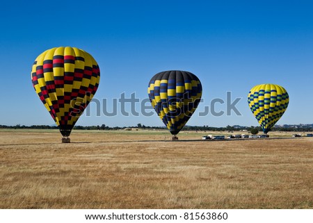 Hot air balloons are landing on a floor of Sacramento Valley in California.