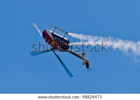SALINAS, CA - SEPT 25: Pilot Chuck Aaron demonstrates the highest level of pilot skills on Red Bull aerobatic helicopter during the California International Airshow, on September 25, 2011, Salinas, CA