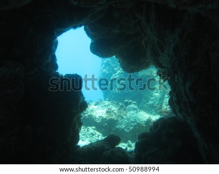Exit of an underwater cavern. Looks out into open water.