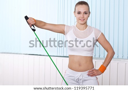 young sport woman doing with resistance expander