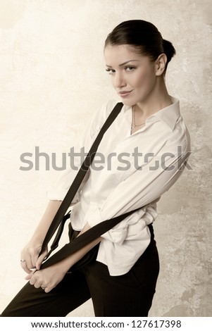 woman in shirt with suspenders. vintage styled. studio fashion shot