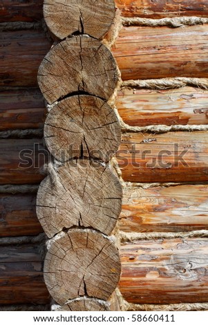Corner of the wooden house constructed of pine logs