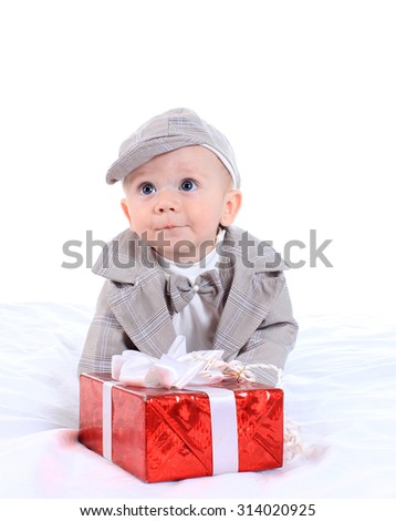 Boy in an interesting dress with a gift box on a white background