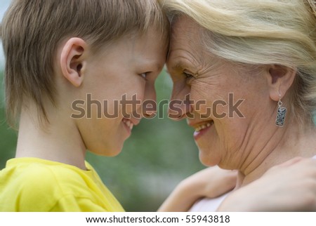 Grandmother with grandson on nature face to face