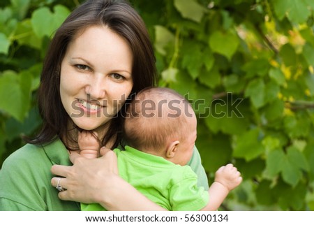 newborn in the arms of mother nature on the background