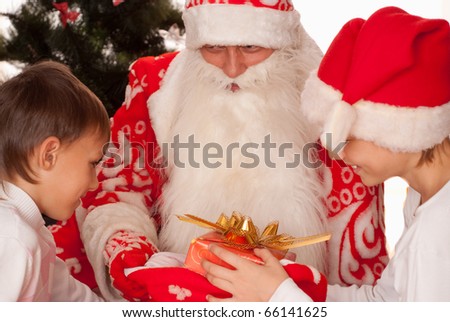 Santa gives presents to children on a white background