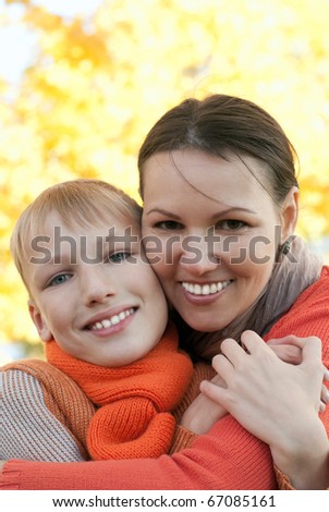 Mom and nice son walking in a park