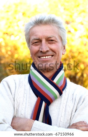 happy elderly man in a autumn park